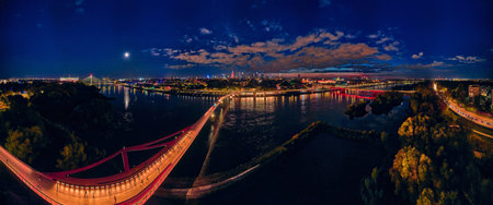 Beautiful panoramic aerial drone night sunset view to the new pedestrian and bicycle bridge...