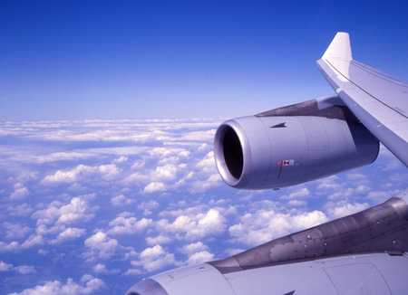 passenger jet above the clouds,right wing in sight.