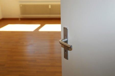 Half open door in an empty apartmentの写真素材