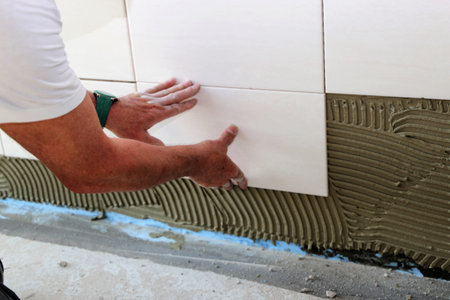 Installing wall tiles, close up
