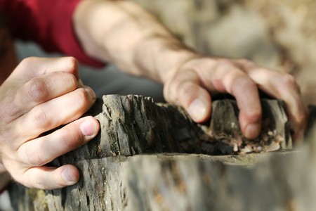 Hands of a climber on difficult rockの写真素材