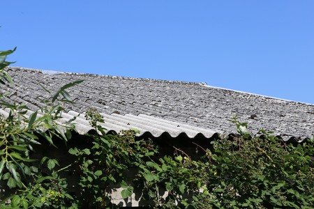 Old building with asbestos roofの写真素材