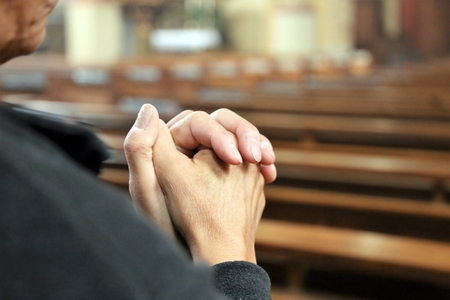 Devout Christian praying in a churchの写真素材