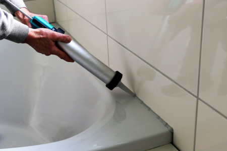 Man sealing a bath or basin with siliconeの写真素材