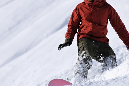 Snowboarder riding the slopeの写真素材