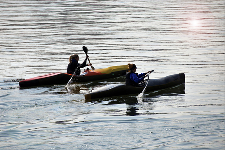 Group of canoeists in the evening sunの写真素材