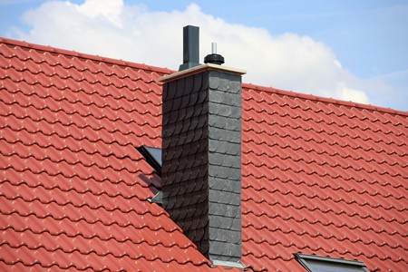 New tiled roof with chimney with slate claddingの写真素材