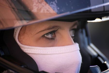 Female race car driver wears helmet and balaclavaの写真素材