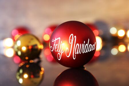Christmas greetings with spanish text Feliz Navidad (merry christmas) and Christmas baublesの写真素材