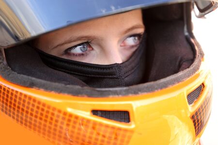 Female race car driver wears helmet and balaclavaの写真素材