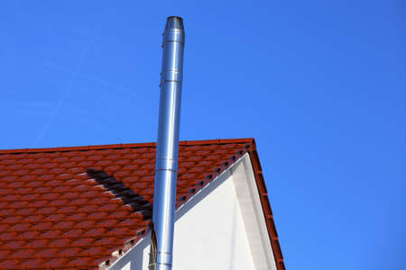Stainless steel chimney on a new residential homeの写真素材