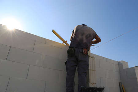 Construction worker (bricklayer) works on the construction siteの写真素材
