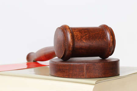 Book and judge's gavel as a symbol image for a court verdictの写真素材