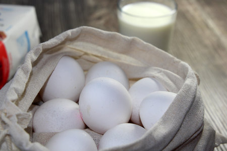 Symbolic image of baking ingredients: Eggs in a fabric bag