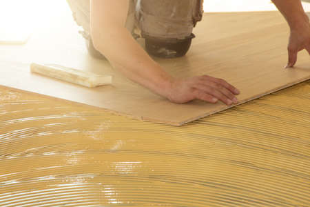 Craftsman laying herringbone parquet flooring professionallyの写真素材