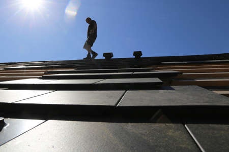 Roofing work, new covering of a tiled roofの写真素材