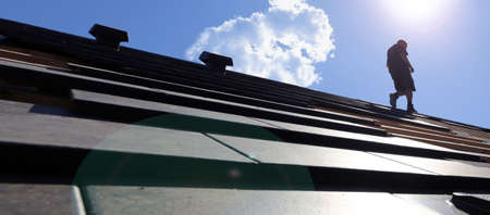 Roofing work, new covering of a tiled roofの写真素材