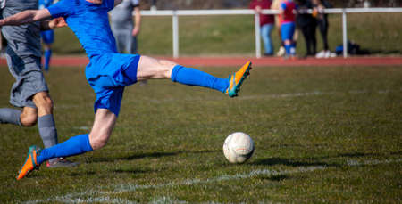 Symbolic image of amateur football: Football players in a duel for the ballの写真素材