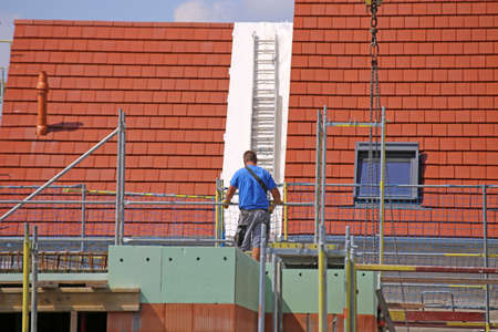 Construction worker (bricklayer) works on the construction siteの写真素材