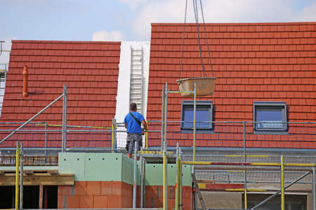 Construction worker (bricklayer) works on the construction siteの写真素材