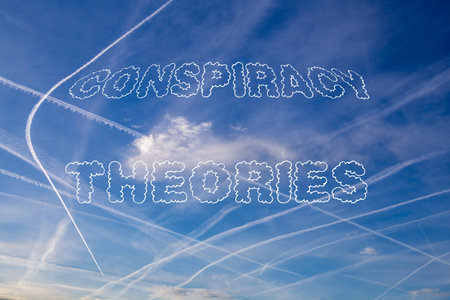 Conspiracy Theories symbolic image: Sky with contrails with the words Conspiracy Theories