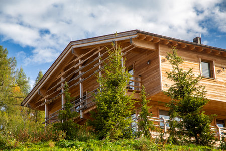 Alpine style wooden house in the mountainsの写真素材
