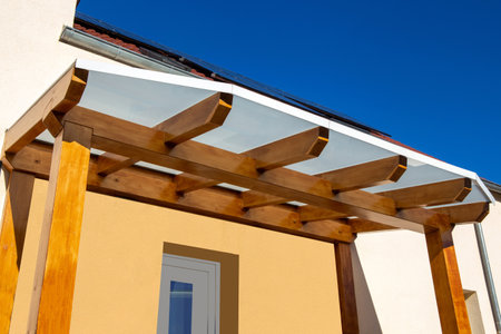 Beautiful wooden canopy at the entrance of a detached houseの写真素材