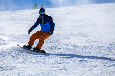 Close up of a snowboarder on the slope (Davos, Switzerland)の写真素材