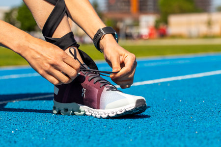 Young female athlete wears running shoes from the Swiss shoe brand ONのeditorial素材
