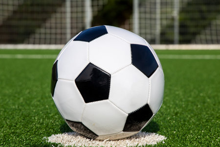 Symbol image: Football on an empty football fieldの写真素材