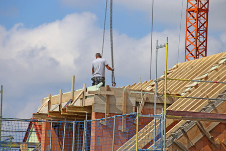 Construction worker (bricklayer) works on the construction siteの写真素材