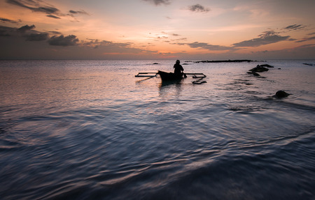 fishermen with traditional boatの写真素材