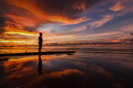 A sad man lost in beautiful sunsetの写真素材