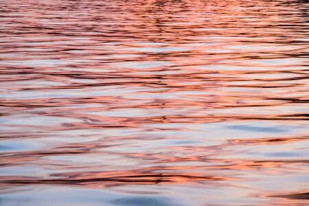 An abstract close up of water ripples on the ocean surface at sunset, in Malta.の写真素材