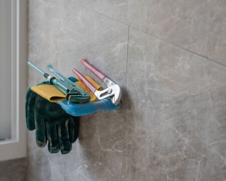Monkey wrench brass plumbing fittings leather safety gloves construction concept.の写真素材