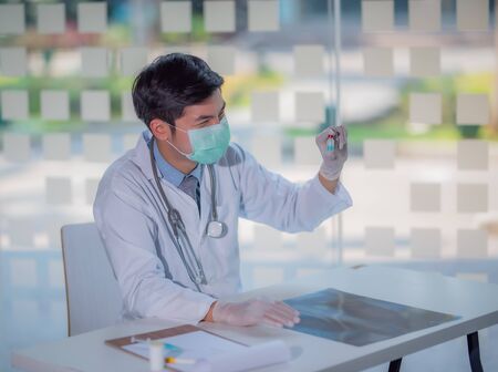 A doctor holding a  liquid vaccines for children or older adults, or cure animal diseases. Concept:diseases,medical care,science, coronavirus.の写真素材