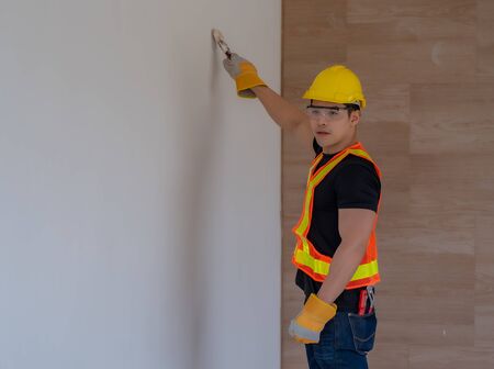 Close the worker's arms, paint the walls with a paint brush.の写真素材