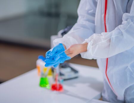Human holding Variation of Latex Glove, human hand is wearing a medical glove.の写真素材