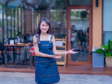 Portrait of female coffee shop owner standing in the storefrontの写真素材