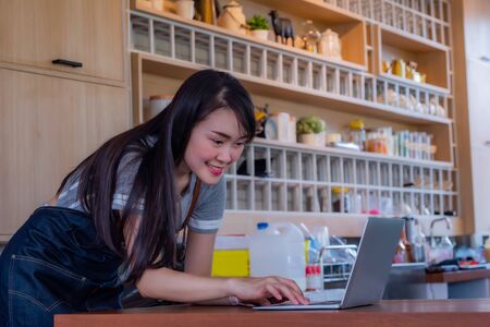 Portrait of female coffee shop owner standing in front of the Counterの写真素材