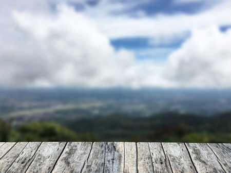Empty wood table top with blurred view of nature background. For product displayの写真素材