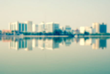 Out of focus vintage: a large building located in the center of the city and the reflection in the water.の写真素材