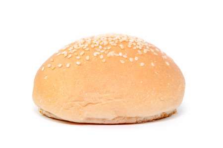 Burger buns sprinkled with sesame seeds on a white background.