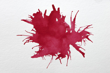 Drop the red watercolors on white paper.の写真素材