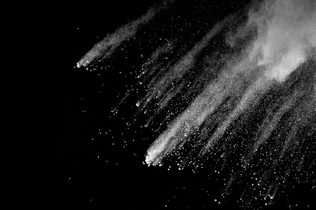 Explosion of white dust on black background.の写真素材