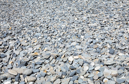 Pebble beach with large and small dry stones, perspective backgroundの写真素材