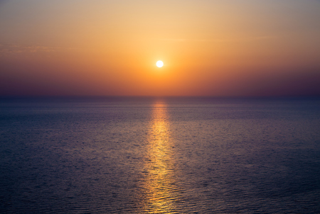 Beautiful sunset over the sea in the Atlantic ocean. Solar path on the waterの写真素材