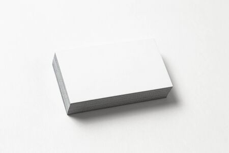 Blank business card on white background. Side view. Standard size. Stylish textured stack of cardboard for personal advertising or corporate design.の写真素材
