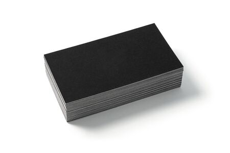 Blank black business card isolated on white background. Side view. Standard size. Stylish textured stack of cardboard for personal advertising or corporate design.の写真素材