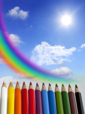 Crayons clouds rainbow and sun concept backgroundの写真素材